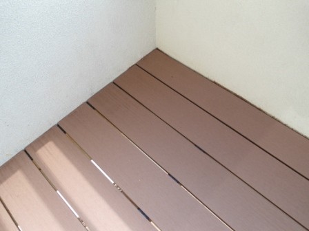 plastic composite decking covering the stained render